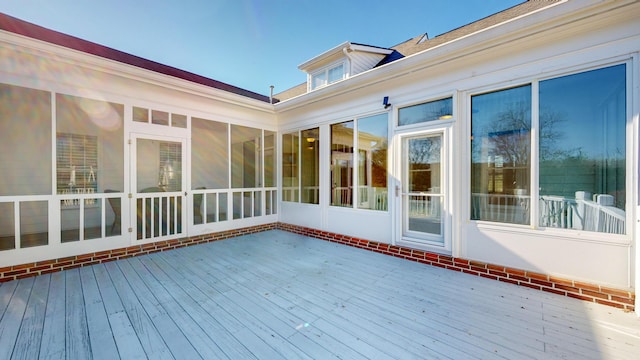 wooden deck featuring a sunroom