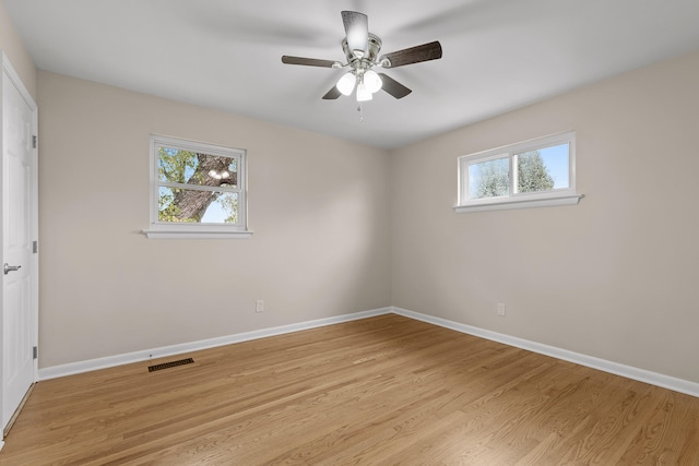 empty room featuring ceiling fan and light hardwood / wood-style flooring