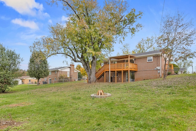 view of yard with a fire pit and a deck