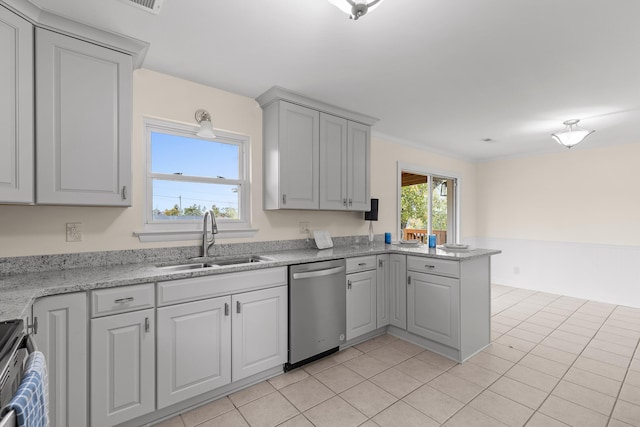 kitchen with kitchen peninsula, appliances with stainless steel finishes, light tile patterned floors, and sink