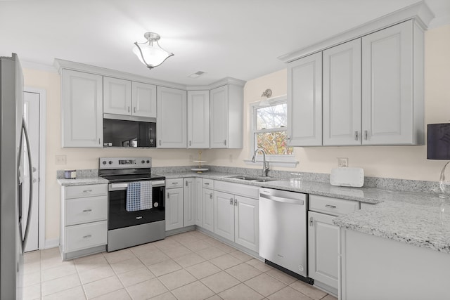 kitchen featuring light tile patterned flooring, sink, white cabinets, and stainless steel appliances