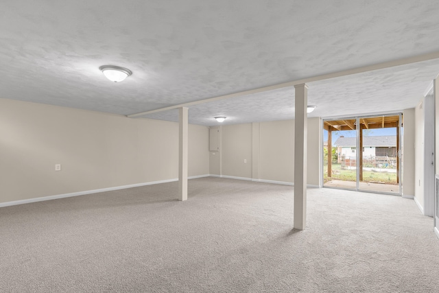 basement with carpet flooring and a textured ceiling