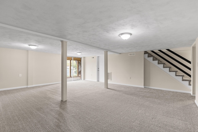 basement featuring carpet and a textured ceiling