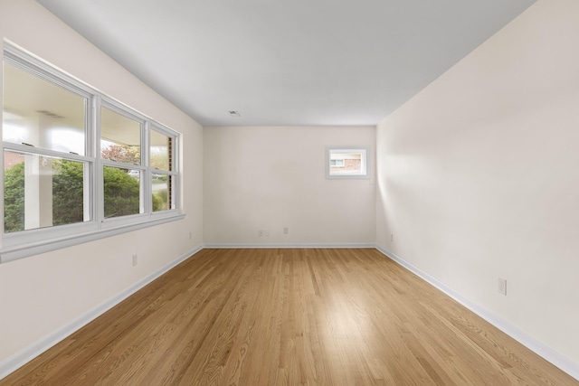 unfurnished room featuring a healthy amount of sunlight and light wood-type flooring