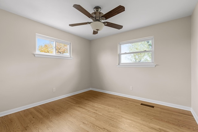 unfurnished room featuring light wood-type flooring, plenty of natural light, and ceiling fan