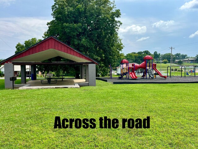 view of community featuring a gazebo, a lawn, and playground community