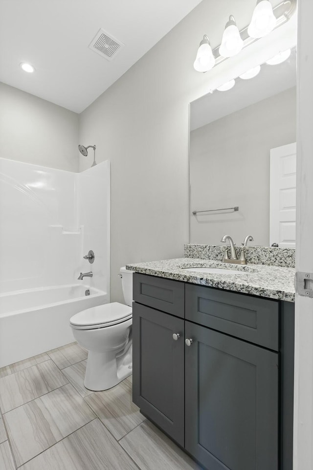 full bathroom with vanity, toilet, and shower / washtub combination