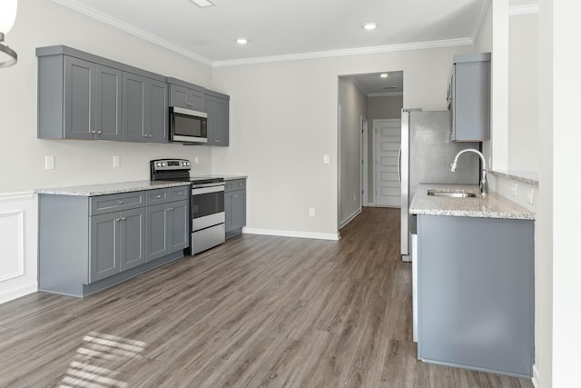 kitchen featuring light stone countertops, appliances with stainless steel finishes, gray cabinets, and dark wood-type flooring