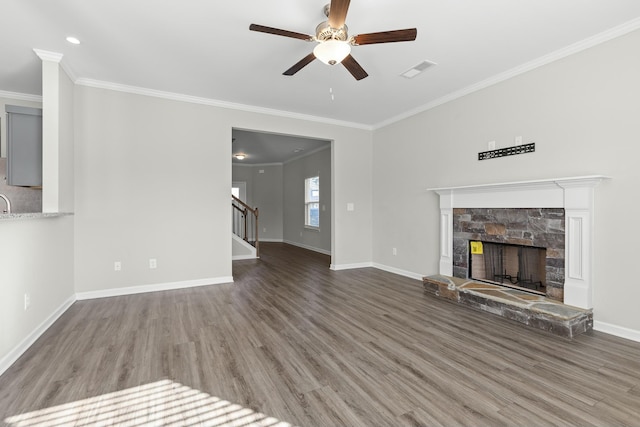 unfurnished living room with a fireplace, hardwood / wood-style flooring, ceiling fan, and ornamental molding