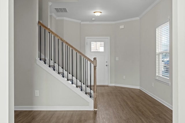 foyer featuring crown molding and dark wood-type flooring