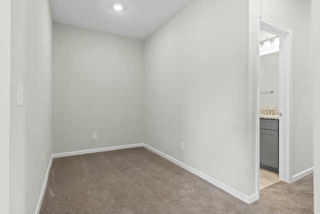 unfurnished room featuring light carpet