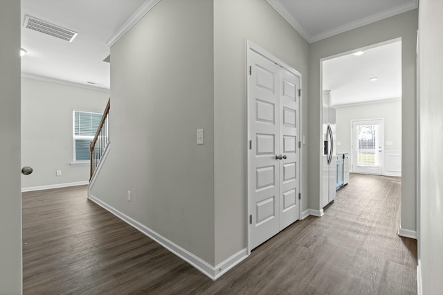 corridor with dark hardwood / wood-style flooring and crown molding