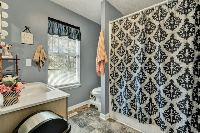 full bathroom with baseboards, toilet, curtained shower, a textured ceiling, and vanity