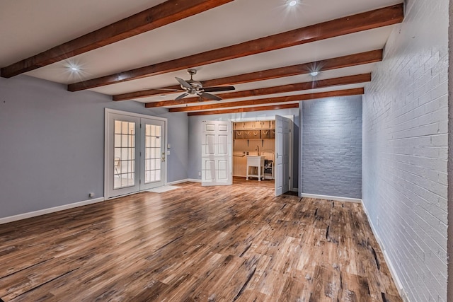 interior space featuring ceiling fan, brick wall, wood finished floors, baseboards, and french doors