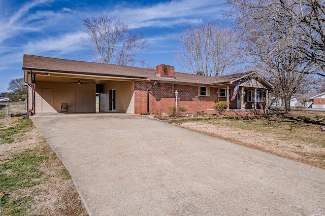 ranch-style home featuring a chimney, aphalt driveway, an attached carport, a porch, and brick siding