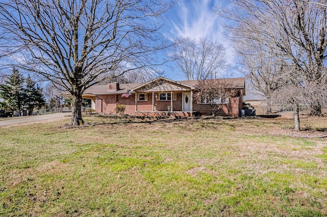 ranch-style house featuring covered porch, a front lawn, and brick siding