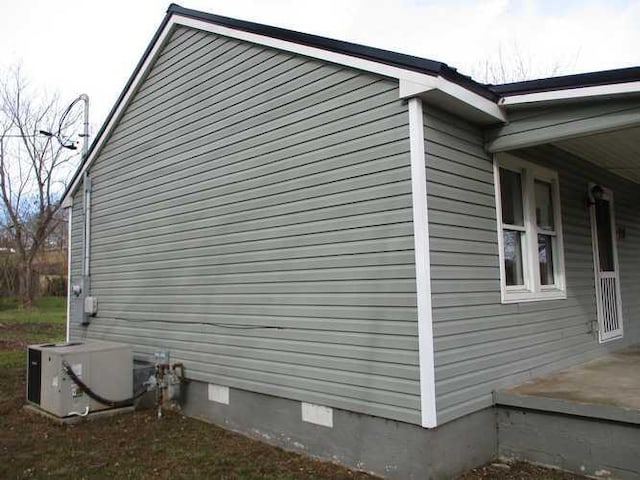 view of side of home featuring central air condition unit