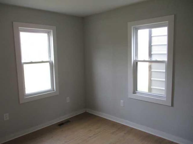 unfurnished room featuring light wood-type flooring