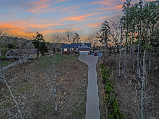 view of front facade with a garage, driveway, and a front yard