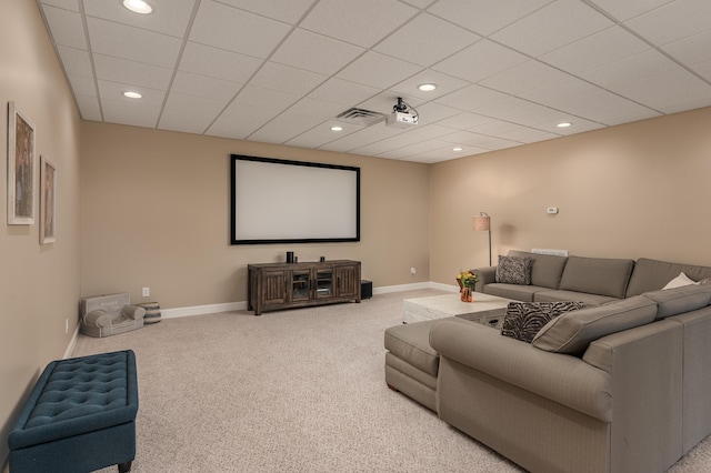 home theater room featuring carpet and a paneled ceiling