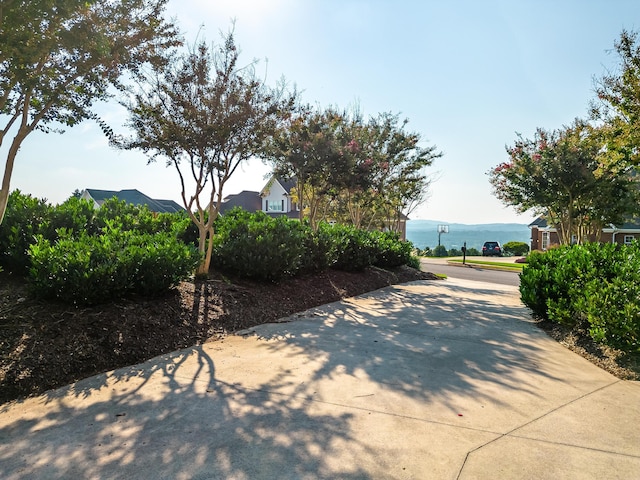 view of patio / terrace with a water and mountain view