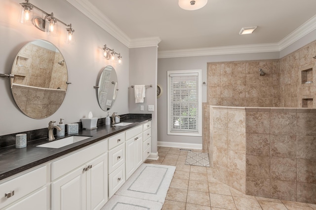 bathroom featuring tile patterned flooring, vanity, tiled shower, and crown molding