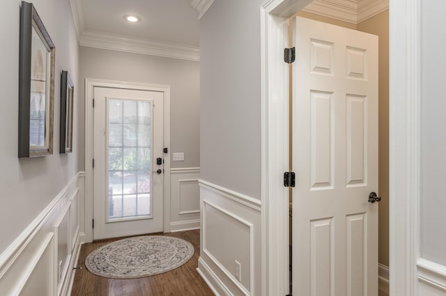 doorway with wood-type flooring and crown molding