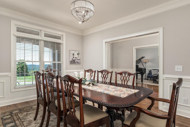 dining space with crown molding, dark hardwood / wood-style flooring, and a notable chandelier