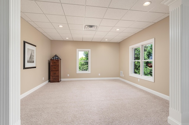 unfurnished room with a drop ceiling and carpet floors