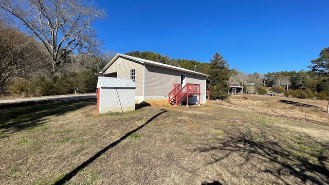 view of outbuilding featuring a yard