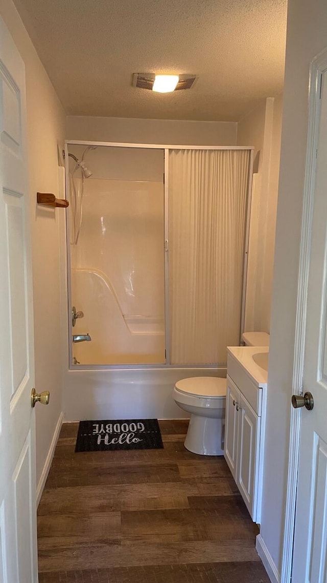 full bathroom featuring hardwood / wood-style floors, vanity, a textured ceiling, and shower / bathtub combination