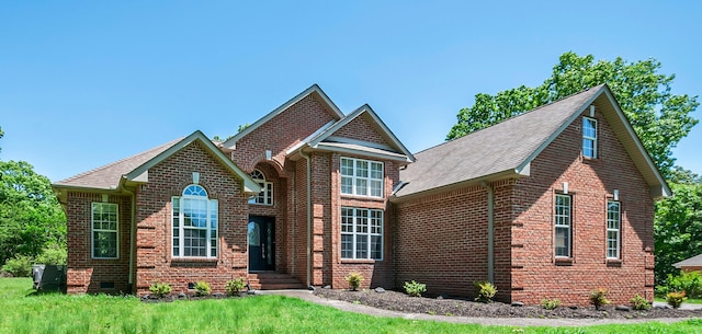 1031 Laurel Hill Dr, Dickson, TN 37055 - view of front of house featuring brick siding, roof with shingles, and a front lawn