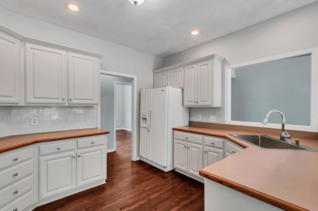 1031 Laurel Hill Dr, Dickson, TN 37055 - kitchen featuring a sink, white fridge with ice dispenser, white cabinetry, dark wood finished floors, and recessed lighting
