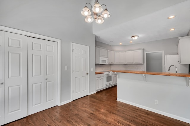 1031 Laurel Hill Dr, Dickson, TN 37055 - kitchen featuring white appliances, wooden counters, a peninsula, white cabinets, and dark wood-style floors