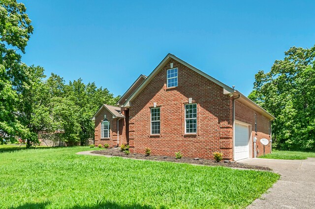 1031 Laurel Hill Dr, Dickson, TN 37055 - view of home's exterior with brick siding, driveway, a yard, and an attached garage