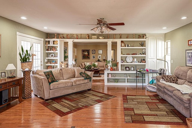 living room with a ceiling fan, recessed lighting, decorative columns, and wood finished floors