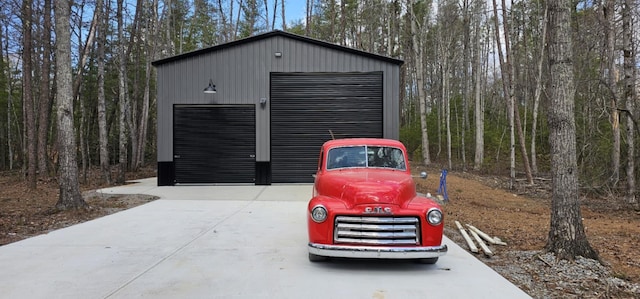 detached garage with a forest view