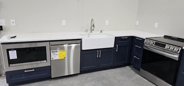 kitchen with stainless steel appliances, light countertops, a sink, and concrete flooring