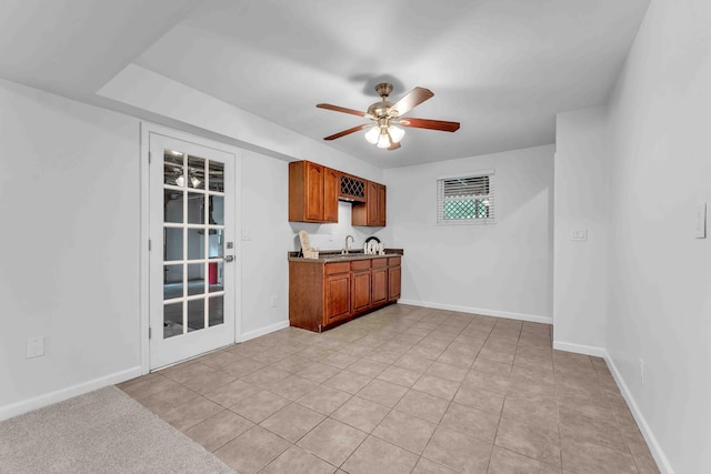 6833 Buck Trail Dr, Harrison, TN 37341 - kitchen featuring a sink, a ceiling fan, brown cabinetry, baseboards, and light tile patterned flooring