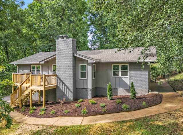 6833 Buck Trail Dr, Harrison, TN 37341 - view of side of property featuring board and batten siding, a chimney, stairway, and roof with shingles