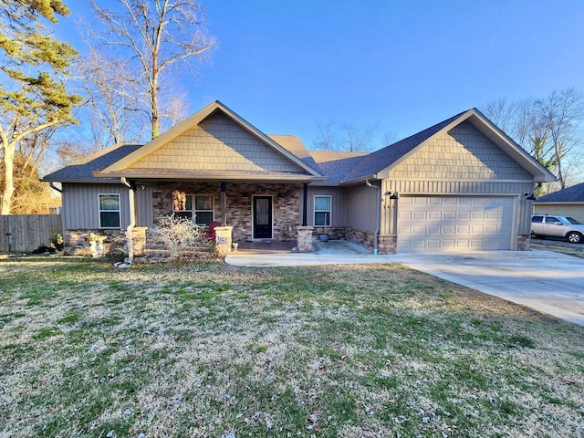 craftsman inspired home featuring a garage and a front lawn