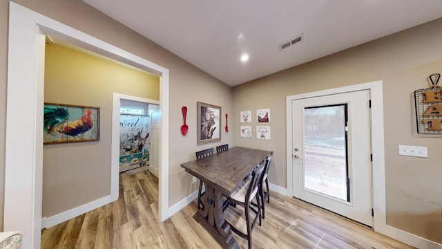 dining space with light wood-type flooring