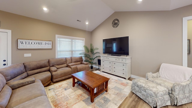 living room featuring vaulted ceiling