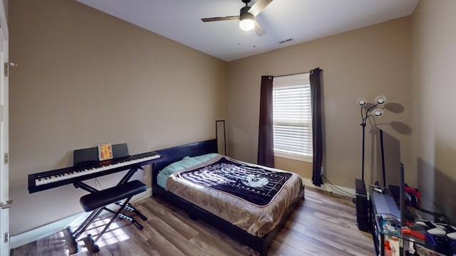 bedroom featuring hardwood / wood-style floors and ceiling fan