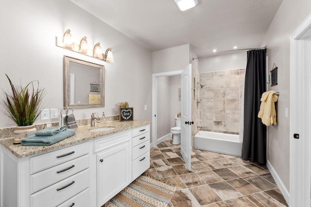 full bathroom with vanity, shower / tub combo with curtain, and toilet