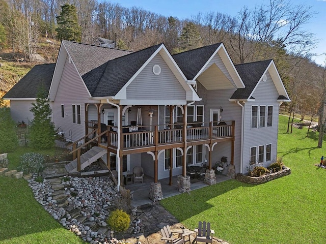 back of property with a patio, a yard, and a deck