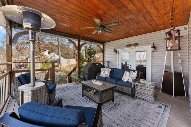 sunroom with wooden ceiling, ceiling fan, and french doors