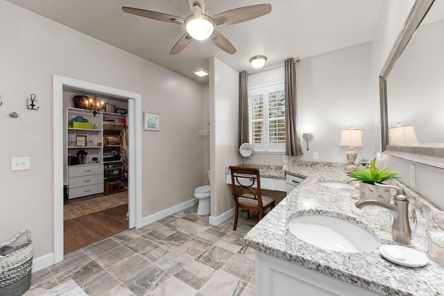 bathroom with vanity, ceiling fan, and toilet