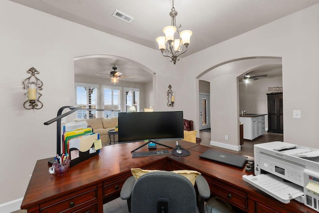 office with sink and ceiling fan with notable chandelier