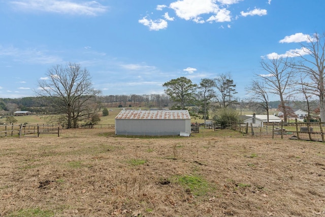 view of yard featuring a rural view and an outdoor structure